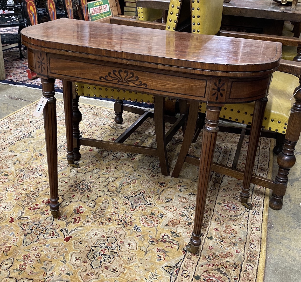 A Regency ebony inlaid mahogany D shaped folding card table, width 92cm, depth 46cm, height 73cm